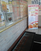 Hot food menu board at service counter of Manhattan Fish and Chicken Market